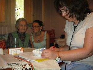 Judit and Imo with a patient at home